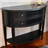 F28. Black demilune two-drawer table 33”h x 38”w x 14”d 